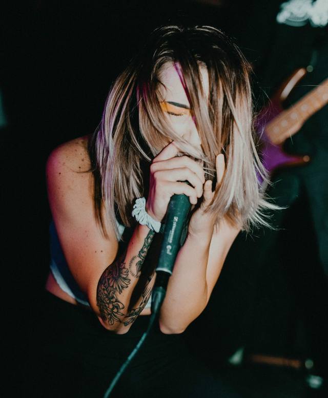 A singer giving it everything into the microphone